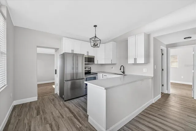 a kitchen with cabinets and stainless steel appliances