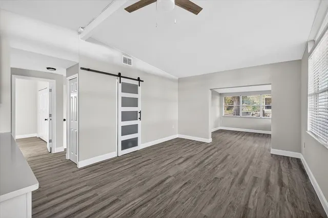 a view of empty room with wooden floor