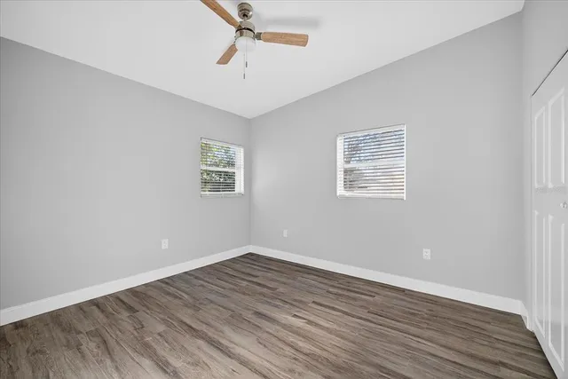 a view of an empty room with wooden floor