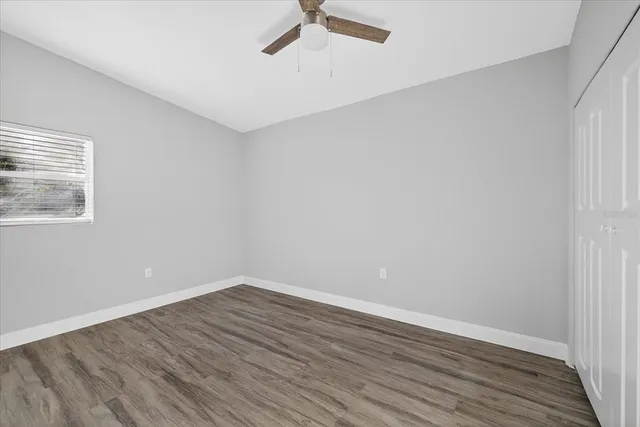 a view of a room with wooden floor and window