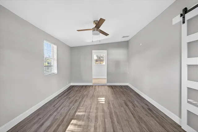 an empty room with windows and closet