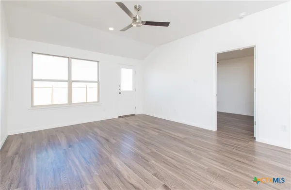 wooden floor in an empty room with a window