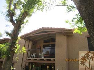 1050 Ramon Road, Unit 127 Palm Springs, CA 92264 - Photo 1 of 25 a view of a house with a tree