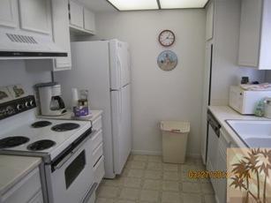 1050 Ramon Road, Unit 127 Palm Springs, CA 92264 - Photo 13 of 25 a kitchen with a refrigerator and a stove