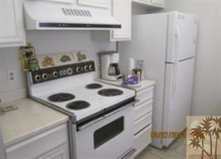 1050 Ramon Road, Unit 127 Palm Springs, CA 92264 - Photo 14 of 25 a kitchen with a stove and a refrigerator