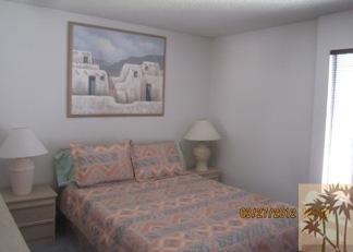 1050 Ramon Road, Unit 127 Palm Springs, CA 92264 - Photo 16 of 25 a bedroom with a bed and a painting on the wall