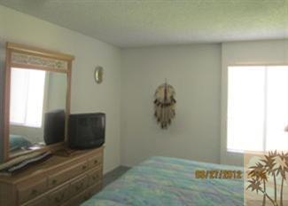 1050 Ramon Road, Unit 127 Palm Springs, CA 92264 - Photo 21 of 25 a living room with furniture and a flat screen tv