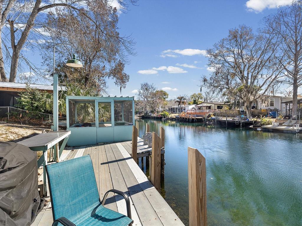 a view of a lake with couches chairs