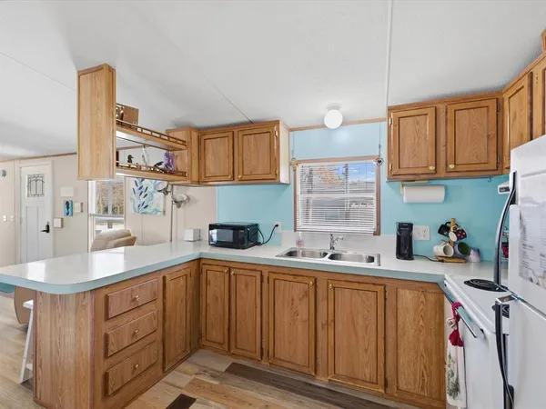 a kitchen with a sink stove and cabinets