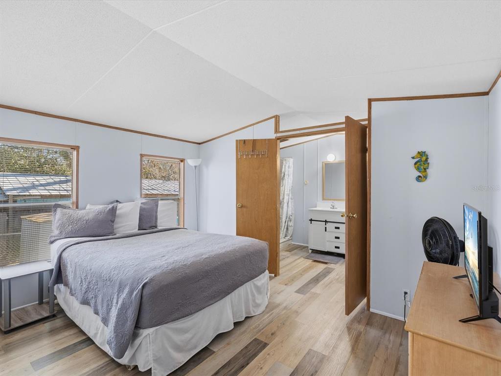 6419 West Richard Drive Weeki Wachee, FL 34607 - Photo 16 of 75 a bedroom with a bed and a dresser