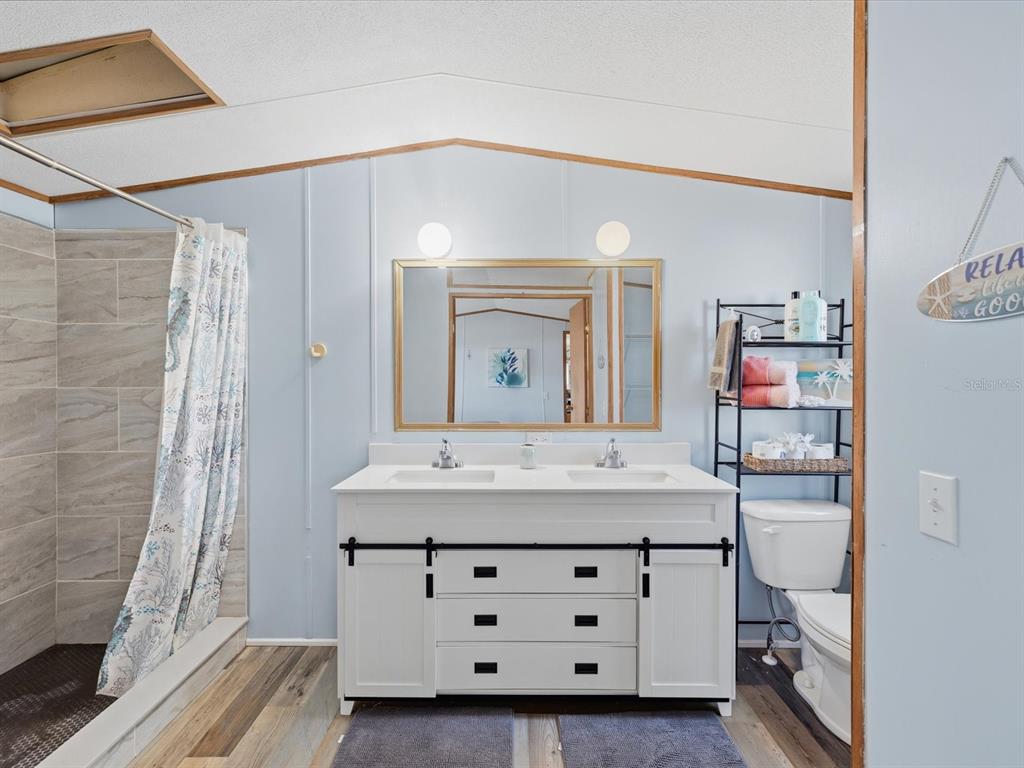 6419 West Richard Drive Weeki Wachee, FL 34607 - Photo 18 of 75 a bathroom with a sink and a mirror