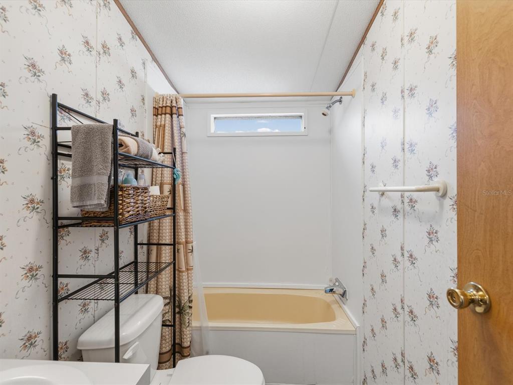 6419 West Richard Drive Weeki Wachee, FL 34607 - Photo 22 of 75 a bathroom with a bathtub and shower