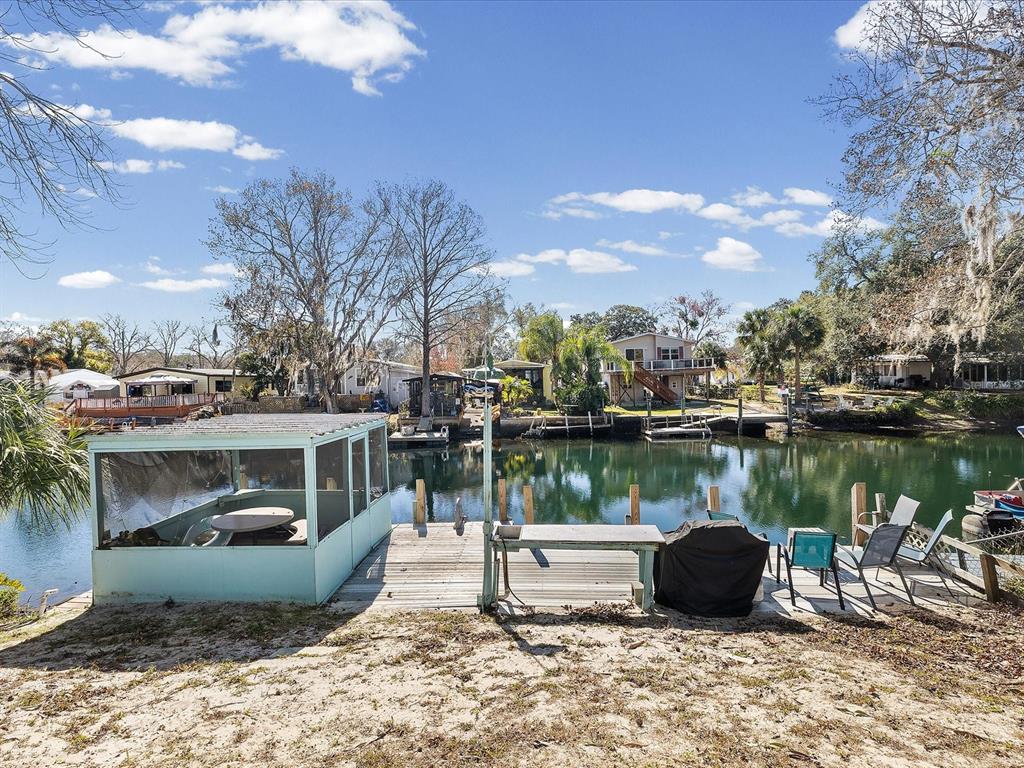6419 West Richard Drive Weeki Wachee, FL 34607 - Photo 29 of 75 a view of a lake with a house and a garden