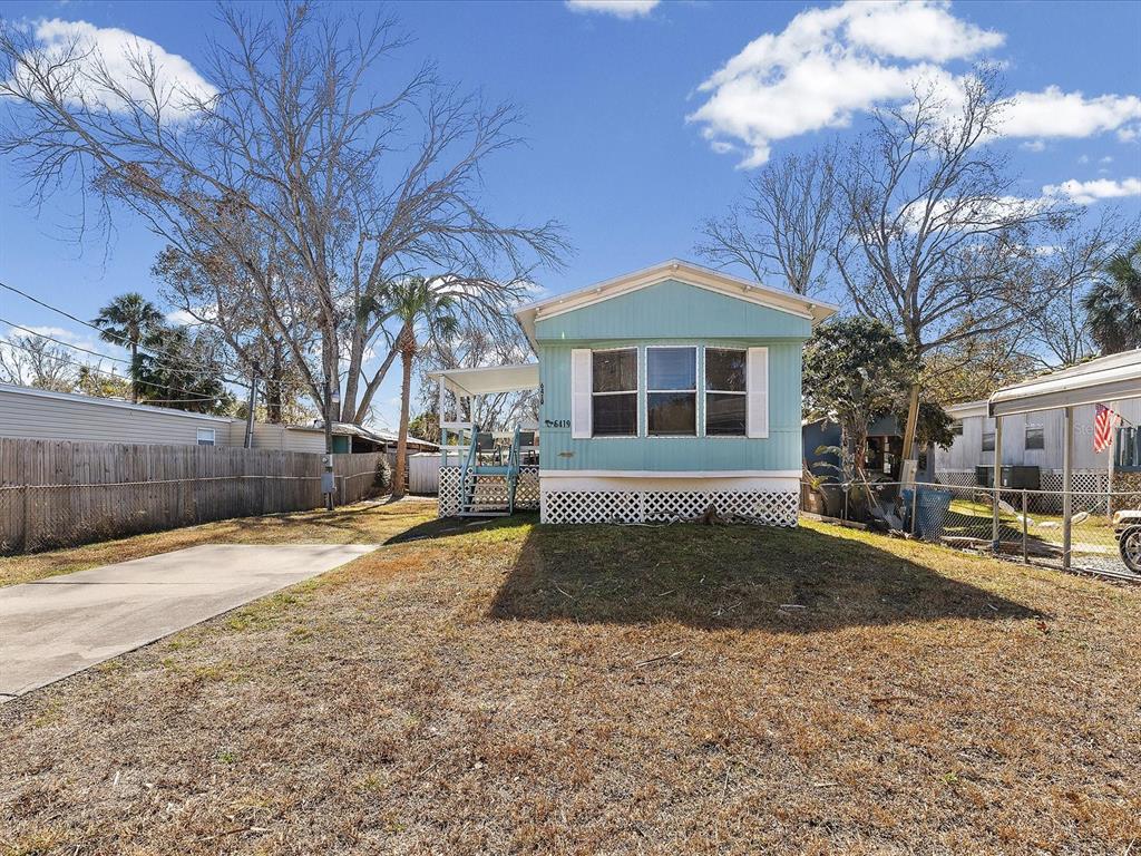 6419 West Richard Drive Weeki Wachee, FL 34607 - Photo 31 of 75 a front view of a house with a yard
