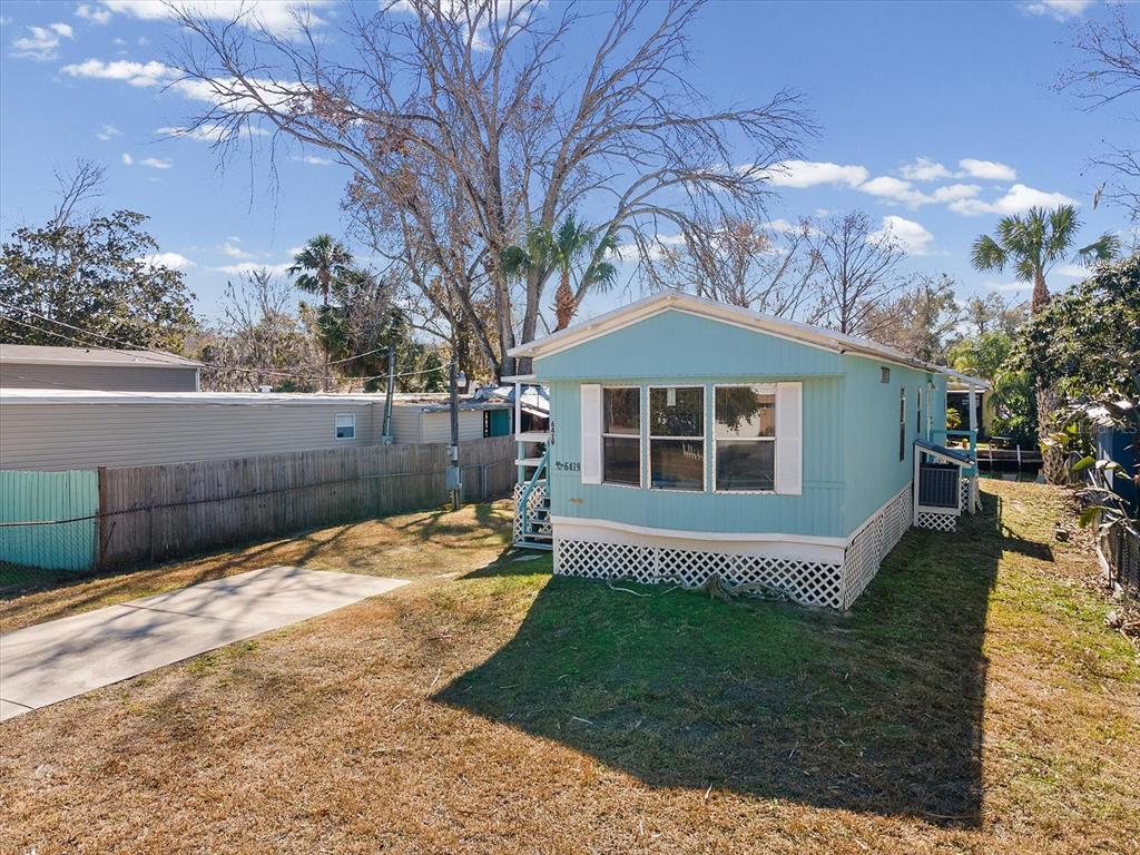 6419 West Richard Drive Weeki Wachee, FL 34607 - Photo 33 of 75 a front view of a house with a yard and garage