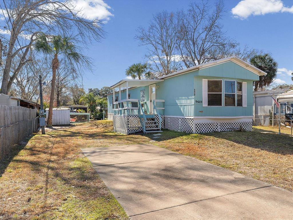 6419 West Richard Drive Weeki Wachee, FL 34607 - Photo 35 of 75 a front view of a house with a yard and garage