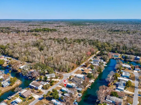 a view of a swimming pool with a yard and seating area