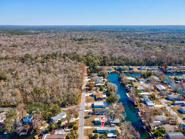 an aerial view of residential houses with outdoor space and lake view