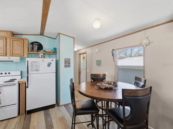 a kitchen with a dining table and chairs