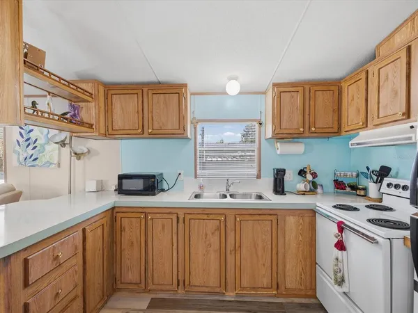 a kitchen with stainless steel appliances granite countertop a sink and cabinets