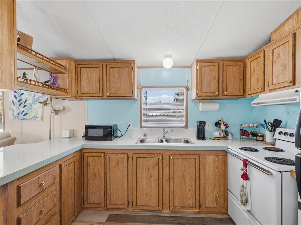 6419 West Richard Drive Weeki Wachee, FL 34607 - Photo 10 of 75 a kitchen with stainless steel appliances granite countertop a sink and cabinets