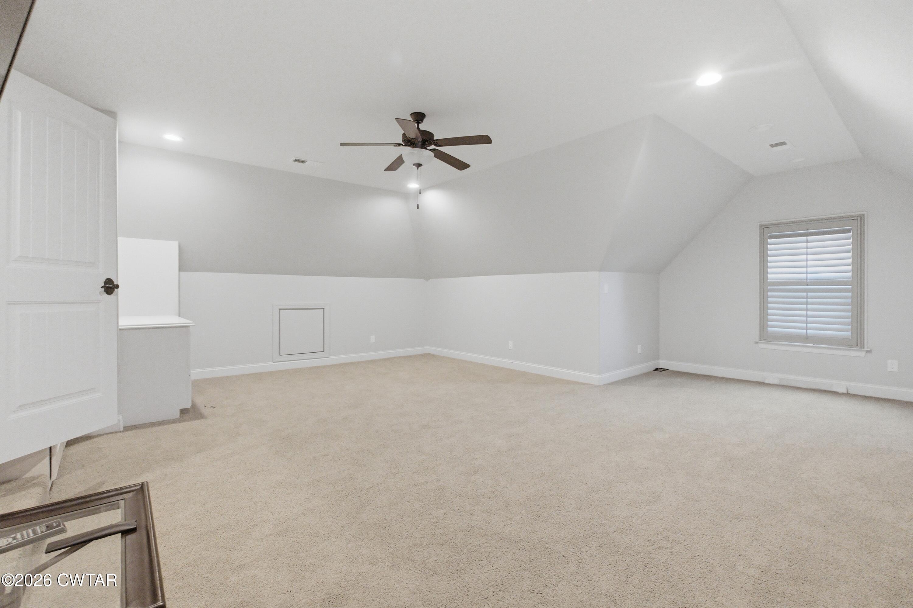 963 Ashport Road Jackson, TN 38305 - Photo 33 of 60 an empty room with chandelier fan and windows