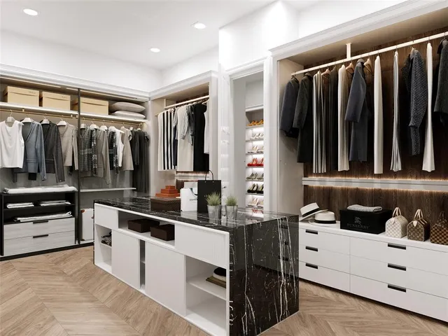 a kitchen with stainless steel appliances kitchen island granite countertop a refrigerator and a sink