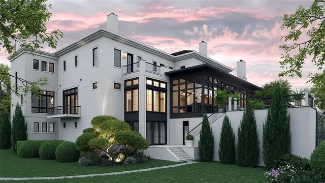 a view of a white house next to a yard with plants and trees