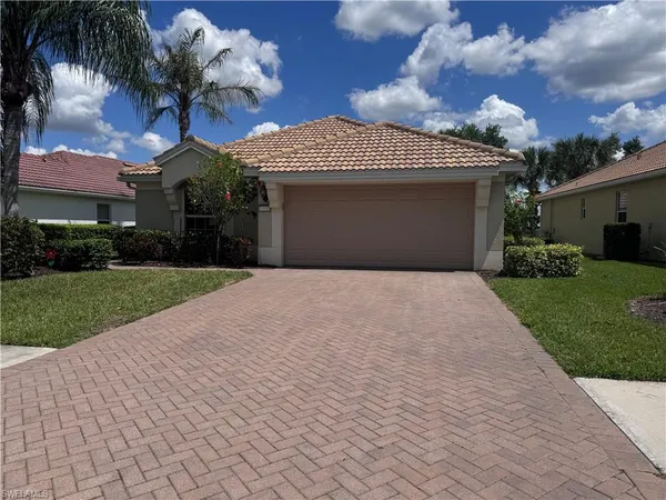 a front view of a house with a yard and a garage