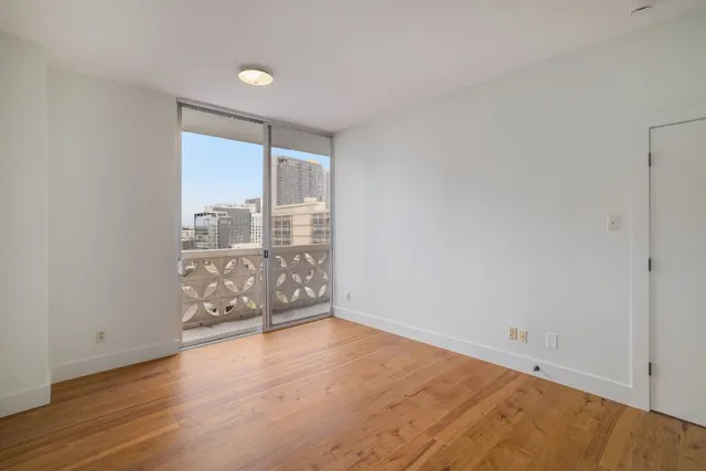 wooden floor in an empty room with a window