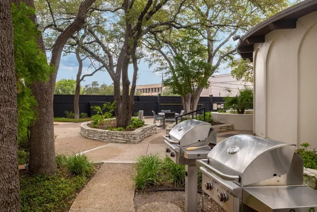a view of swimming pool with outdoor seating and plants