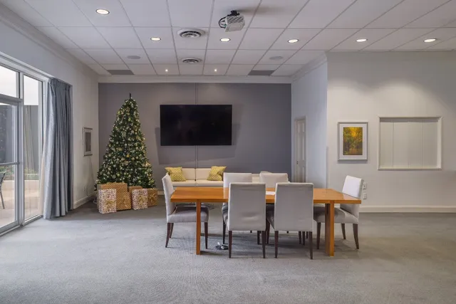 a dining room with furniture a chandelier and window