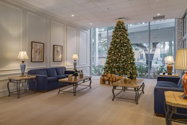 a living room with furniture and a christmas tree