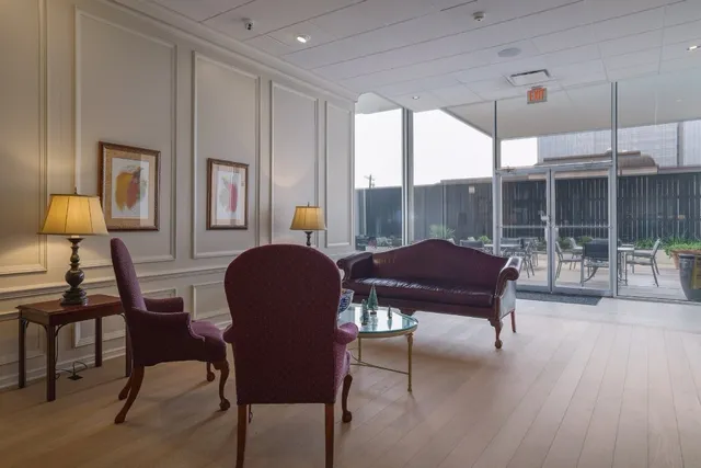 a living room with furniture and a lamp