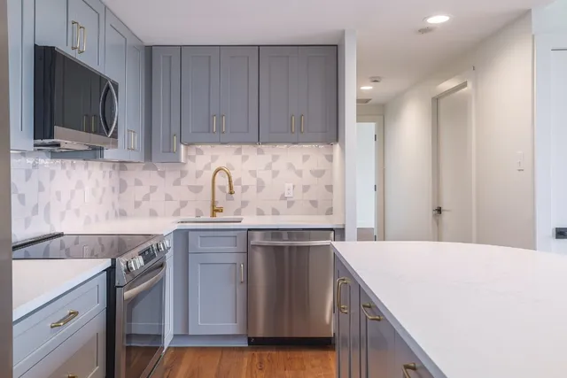a kitchen with a sink cabinets and stainless steel appliances