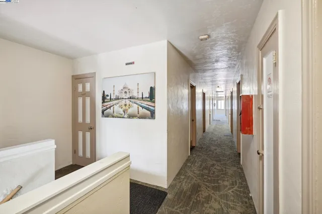 a hallway with front door wooden floor and closet