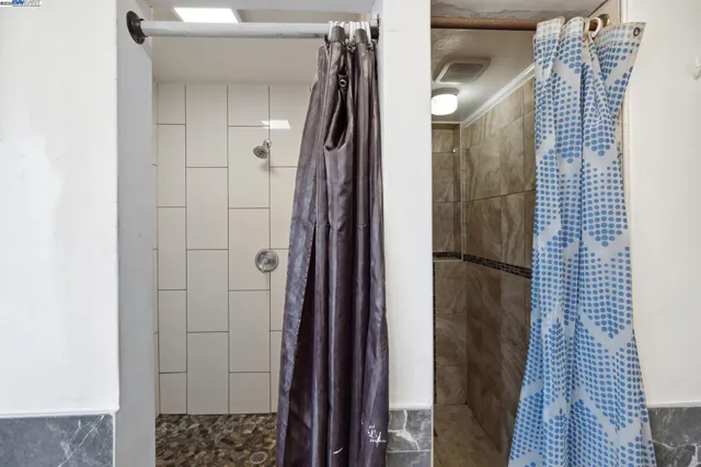 a bathroom with a shower and a glass door