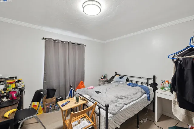 a bedroom with a bed and a table in it