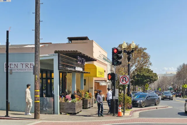 a view of a street with stores