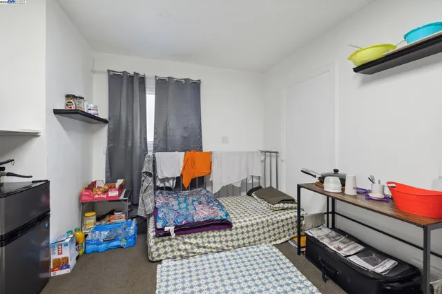 a bedroom with furniture and a lamp