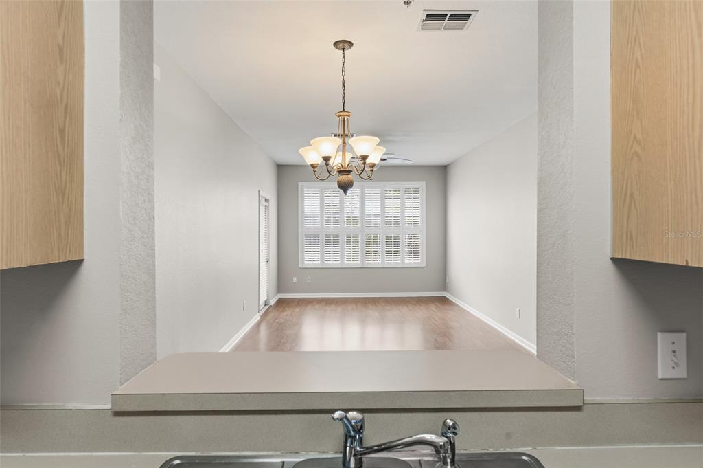 1224 South Hiawassee Road, Unit 636 Orlando, FL 32835 - Photo 12 of 43 a view of a livingroom with wooden floor and a chandelier