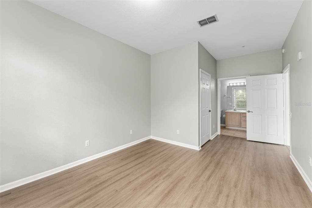 1224 South Hiawassee Road, Unit 636 Orlando, FL 32835 - Photo 17 of 43 a view of a big room with wooden floor and a window