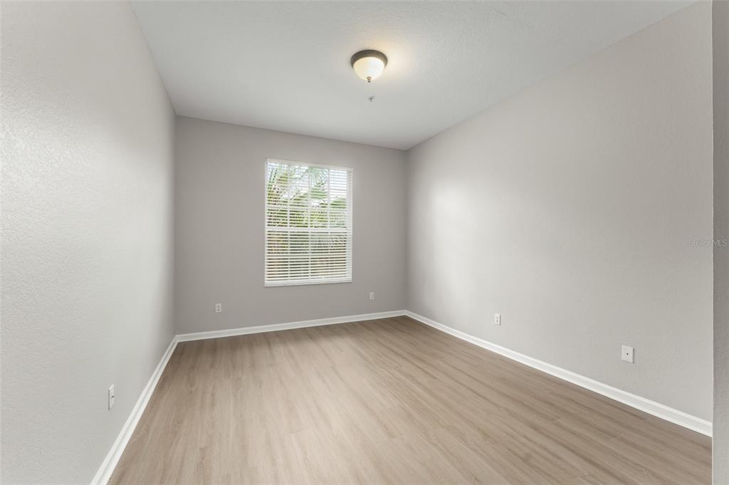 1224 South Hiawassee Road, Unit 636 Orlando, FL 32835 - Photo 20 of 43 an empty room with wooden floor and windows