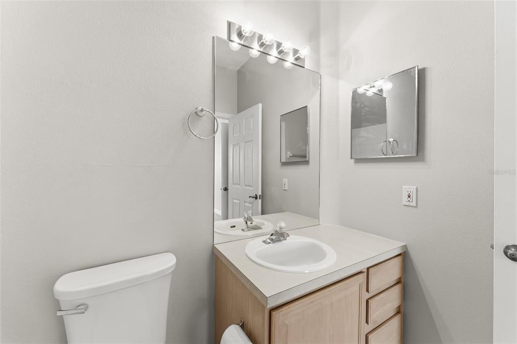 1224 South Hiawassee Road, Unit 636 Orlando, FL 32835 - Photo 21 of 43 a bathroom with a sink toilet and mirror