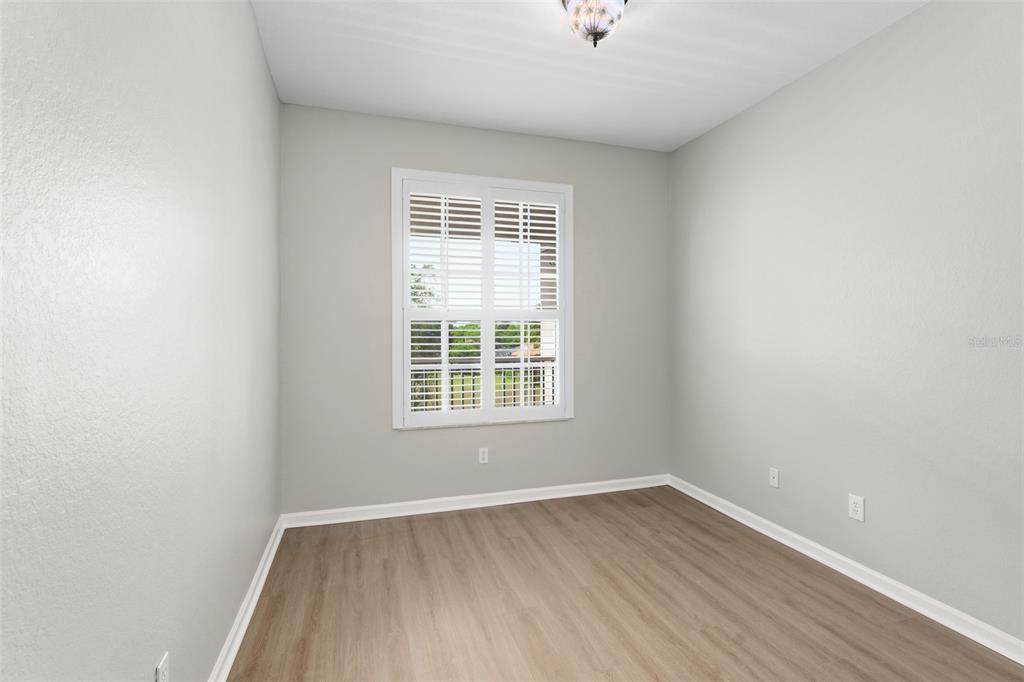 1224 South Hiawassee Road, Unit 636 Orlando, FL 32835 - Photo 22 of 43 an empty room with wooden floor and windows