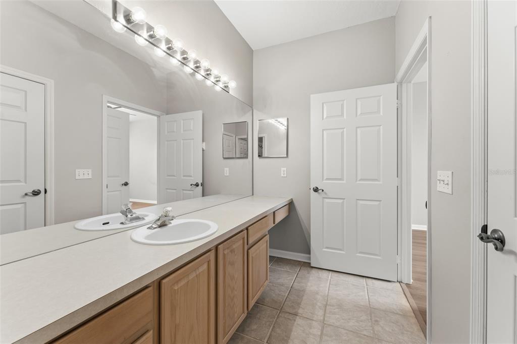 1224 South Hiawassee Road, Unit 636 Orlando, FL 32835 - Photo 25 of 43 a bathroom with a sink a vanity and a mirror