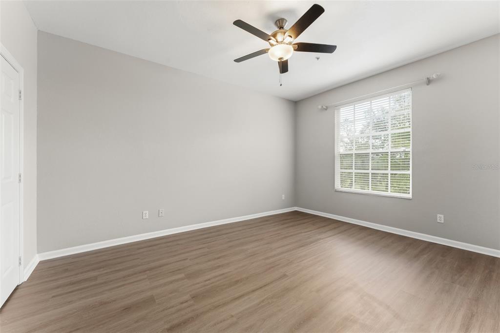 1224 South Hiawassee Road, Unit 636 Orlando, FL 32835 - Photo 28 of 43 an empty room with wooden floor and windows