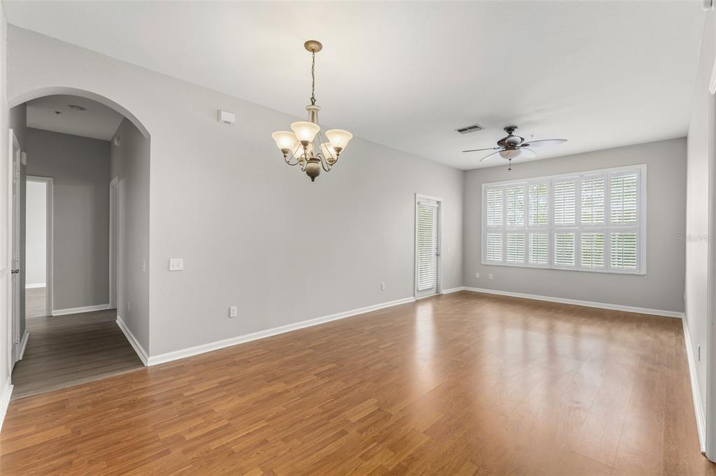 1224 South Hiawassee Road, Unit 636 Orlando, FL 32835 - Photo 6 of 43 a view of an empty room with wooden floor and a window