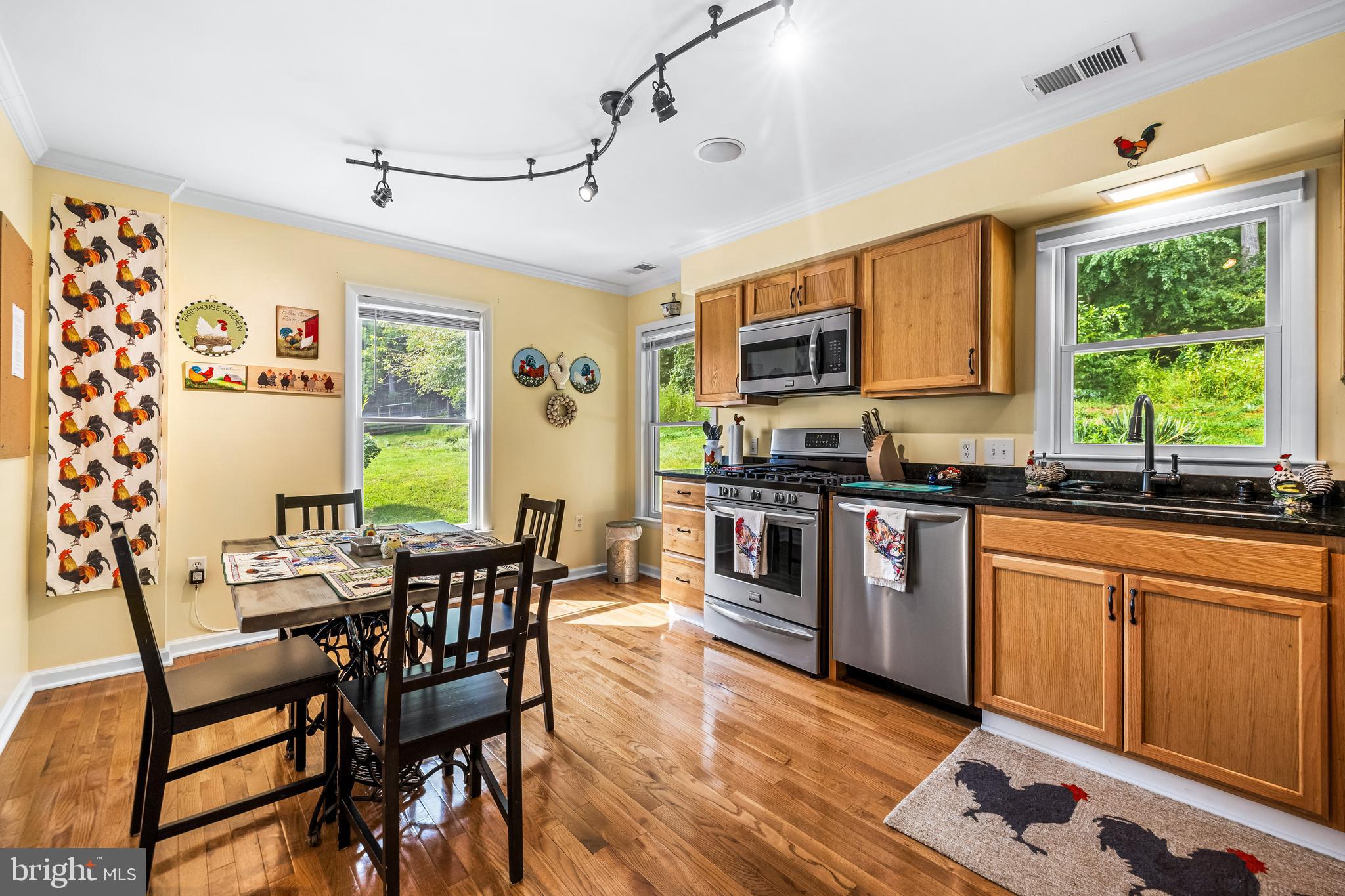 14921 Tanyard Road Sparks Glencoe, MD 21152 - Photo 125 of 150 a kitchen with stainless steel appliances granite countertop a stove a sink dishwasher a dining table and chairs with wooden floor