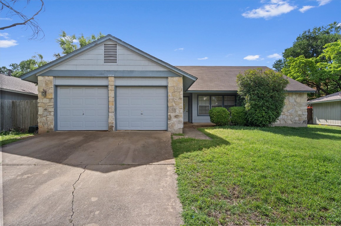 11614 Tanglebriar Trail Austin, TX 78750 - Photo 1 of 1 a front view of a house with a yard and garage